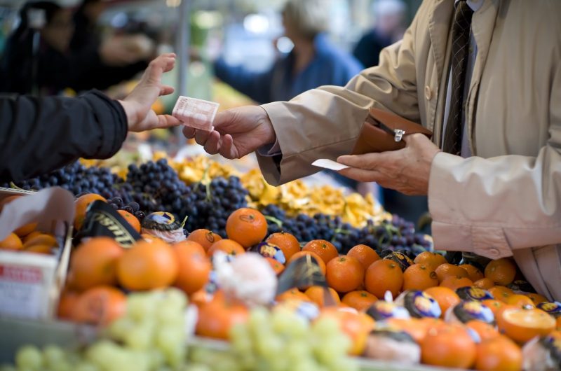 Vendor accepts payment at a street market